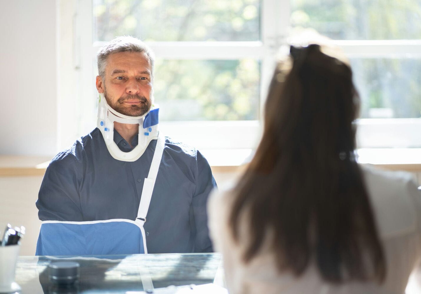 Patient wearing a neck brace during a clinical consultation