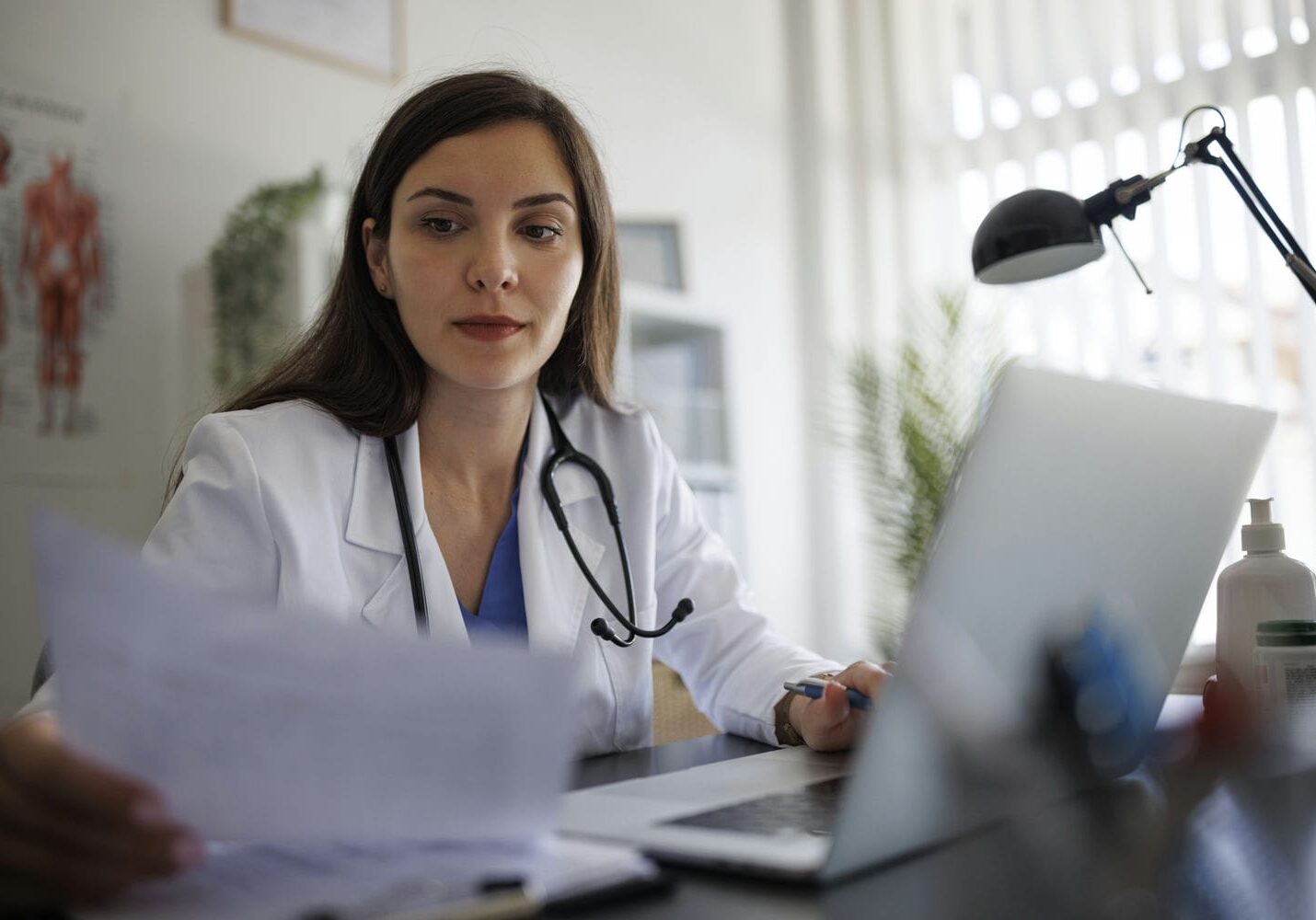 Clinician reviewing documents during an independent medical evaluation