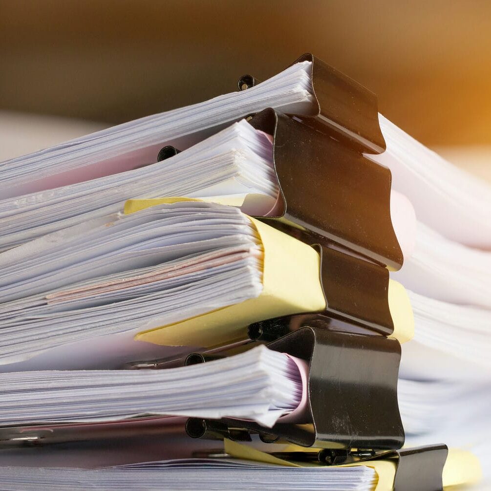 Stacked binders containing organized medical and legal case documents