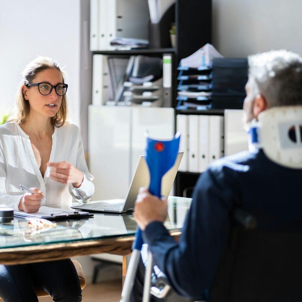 Clinician discussing assessment details with a patient during an OCF-19 evaluation