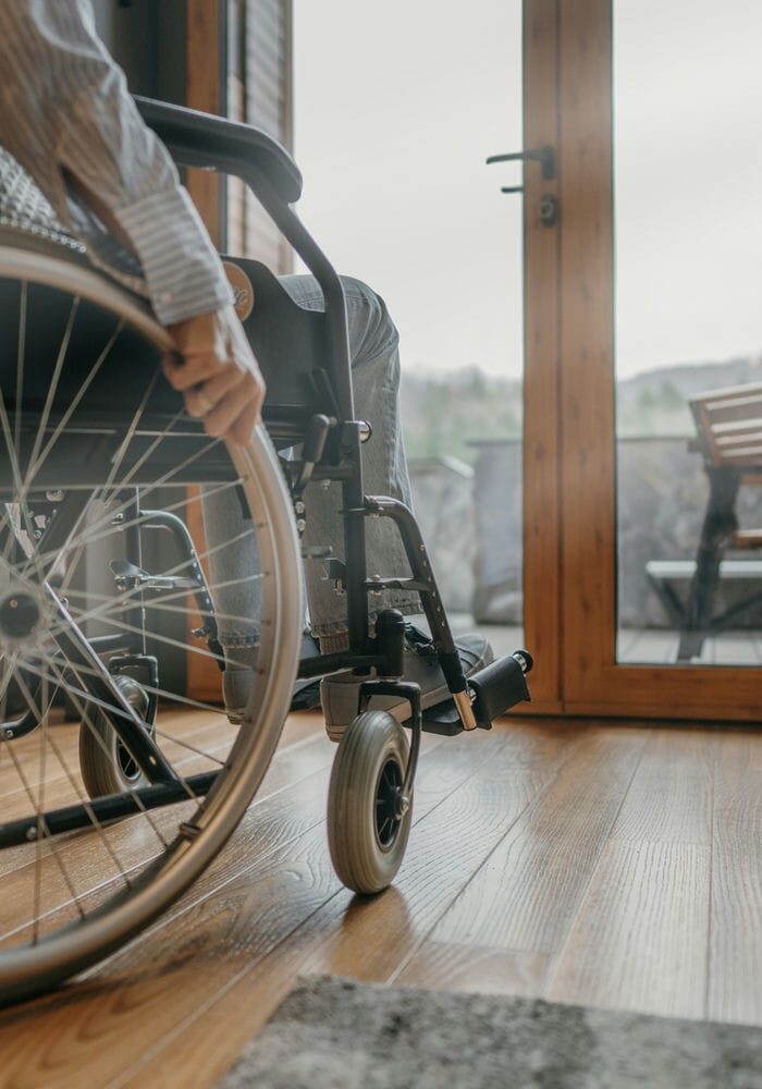 Person using a wheelchair inside a home setting